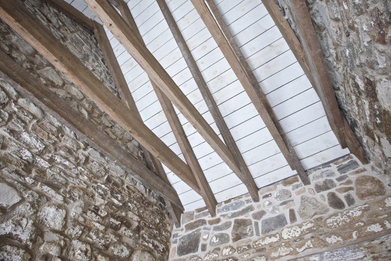 View of new timber roof trusses in a stone barn, Altyre Estate renovations of agricultural buildings, Scotland
